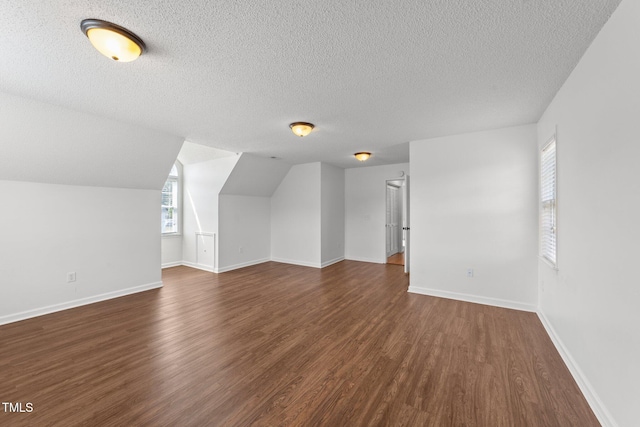 1308 Aspen Falls Ct, Willow Springs, NC 27592 - bonus room featuring a textured ceiling, dark wood finished floors, and baseboards