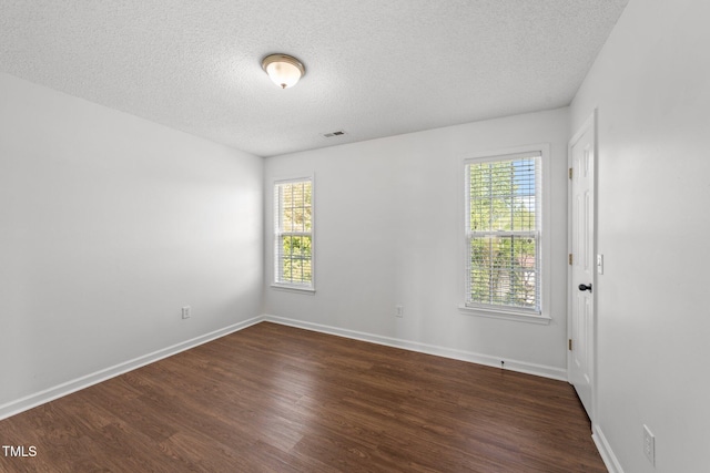 1308 Aspen Falls Ct, Willow Springs, NC 27592 - spare room with baseboards, dark wood finished floors, a textured ceiling, and visible vents