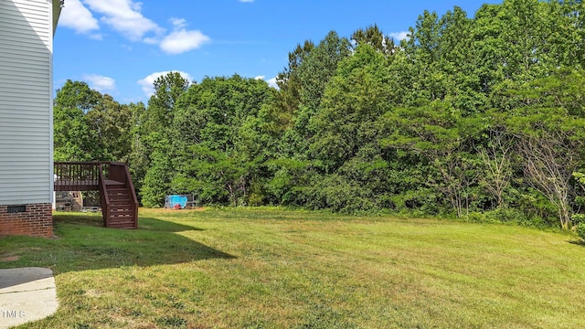 1308 Aspen Falls Ct, Willow Springs, NC 27592 - view of yard featuring a deck, a wooded view, and stairs