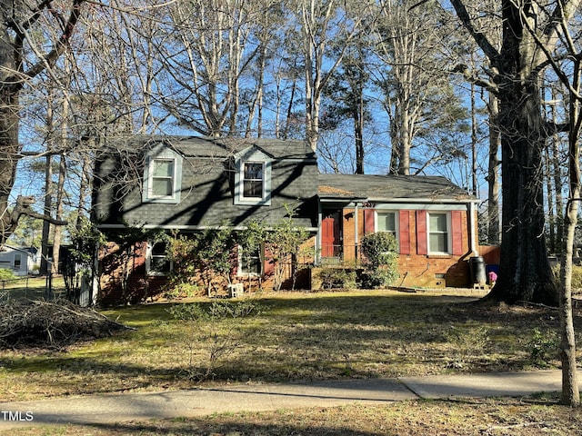 view of front of home with brick siding and a front lawn