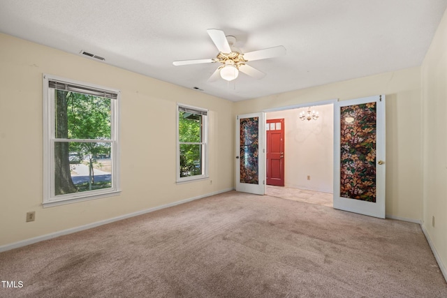 carpeted spare room with plenty of natural light, ceiling fan, and baseboards