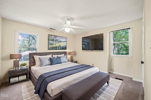 bedroom with carpet, multiple windows, and baseboards