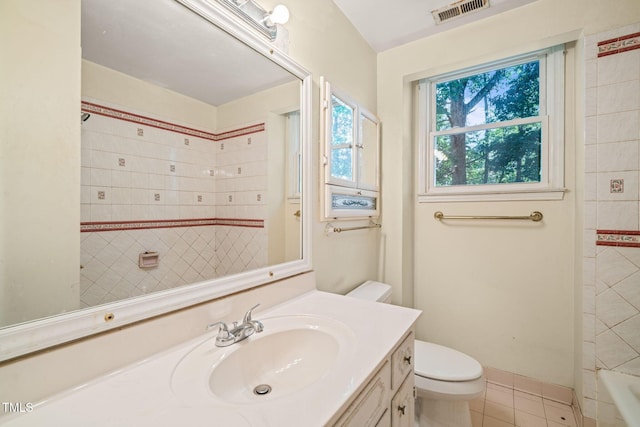 bathroom with tile patterned floors, toilet, vanity, a bath, and a shower