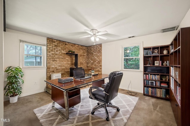office area featuring a ceiling fan, carpet, and baseboards