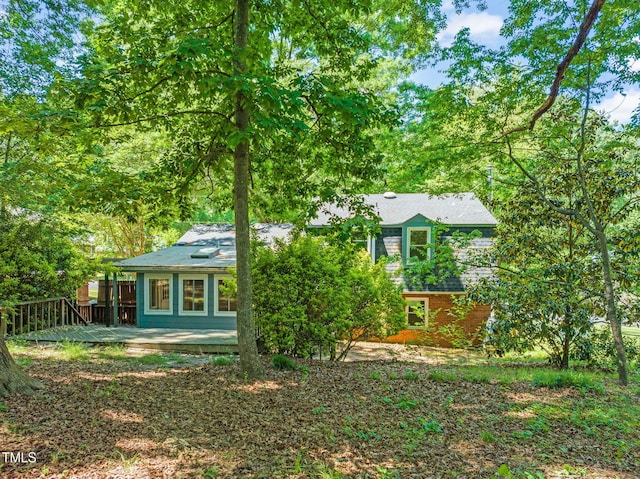back of house featuring a deck
