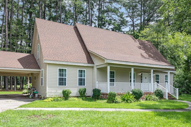 4610 Pinehurst Dr N, Wilson, NC 27896 - view of front of house featuring covered porch, roof with shingles, a front yard, driveway, and a carport