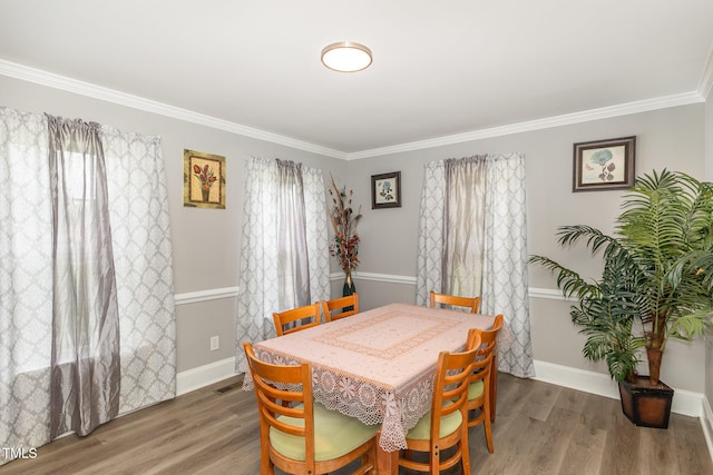 4610 Pinehurst Dr N, Wilson, NC 27896 - dining room with ornamental molding, baseboards, and wood finished floors