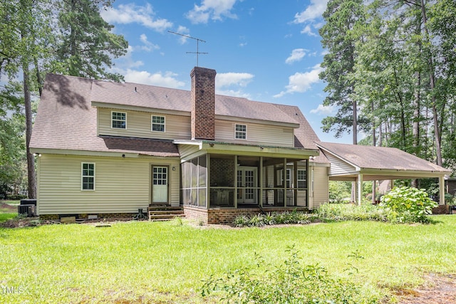 4610 Pinehurst Dr N, Wilson, NC 27896 - back of property with a chimney, a sunroom, a yard, a carport, and roof with shingles