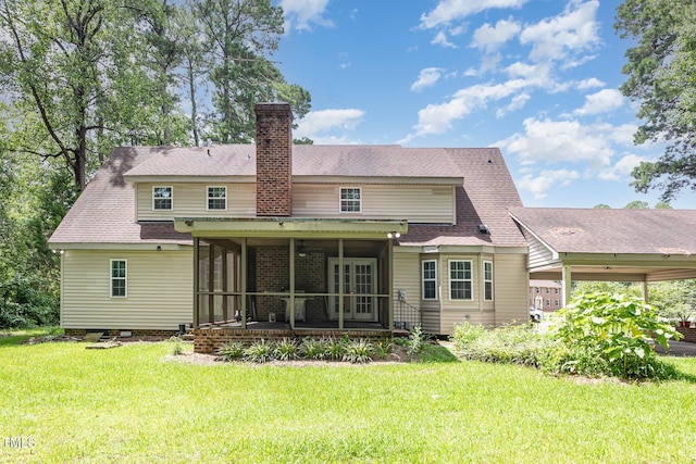 4610 Pinehurst Dr N, Wilson, NC 27896 - rear view of house with a sunroom, a lawn, a chimney, and roof with shingles