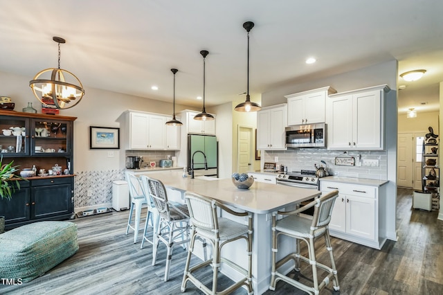 kitchen featuring white cabinetry, light countertops, a sink, and appliances with stainless steel finishes