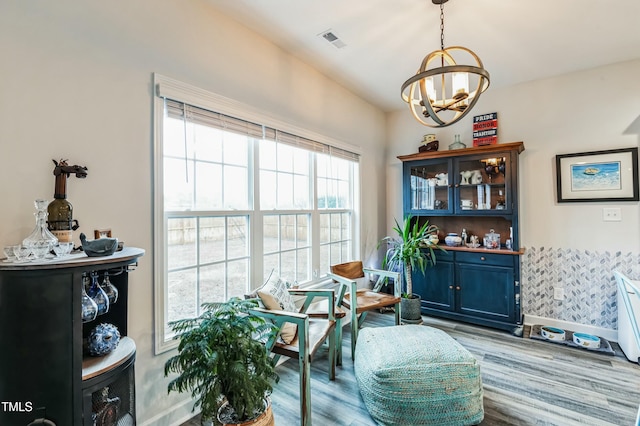sitting room featuring a notable chandelier, visible vents, and wood finished floors
