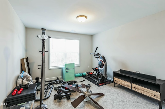 workout area featuring carpet flooring and baseboards