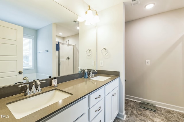 bathroom with baseboards, double vanity, a sink, and a shower stall