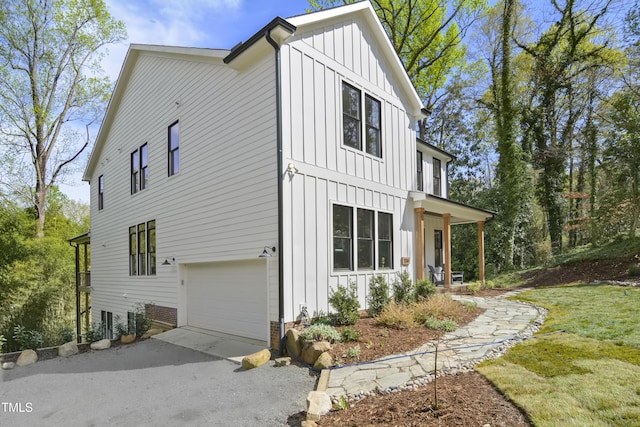 1200 Roosevelt Dr, Chapel Hill, NC 27514 - view of side of home with an attached garage, board and batten siding, and aphalt driveway