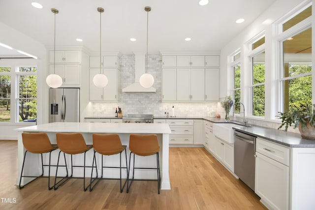 1200 Roosevelt Dr, Chapel Hill, NC 27514 - kitchen featuring a kitchen island, wall chimney exhaust hood, decorative backsplash, and appliances with stainless steel finishes