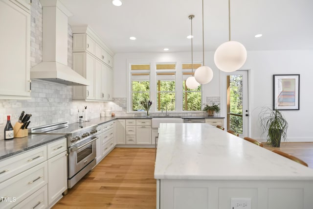1200 Roosevelt Dr, Chapel Hill, NC 27514 - kitchen with a sink, appliances with stainless steel finishes, decorative backsplash, and wall chimney exhaust hood