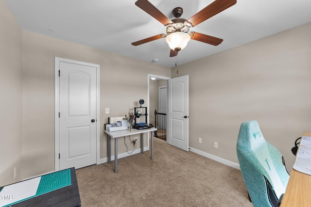office featuring baseboards, a ceiling fan, and carpet floors