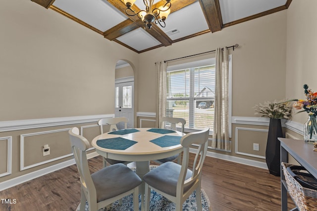 dining room featuring visible vents, arched walkways, an inviting chandelier, a decorative wall, and coffered ceiling
