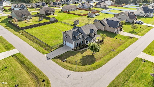 birds eye view of property with a residential view