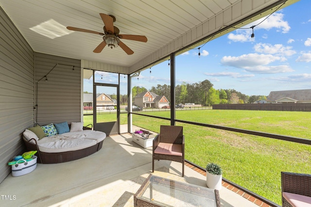 sunroom with an outdoor living space and a ceiling fan