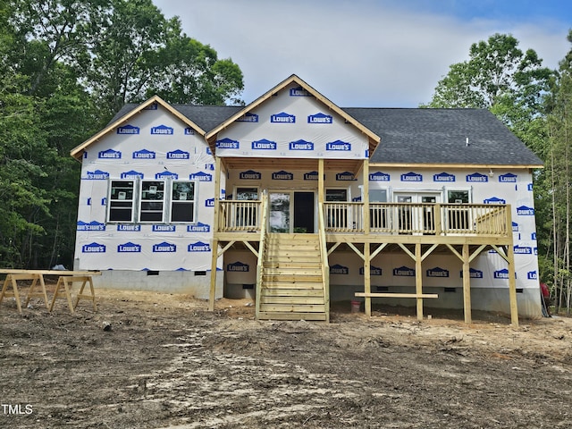 rear view of house featuring crawl space, roof with shingles, and stairs