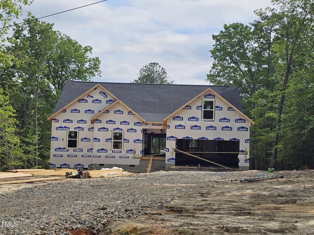 property in mid-construction with roof with shingles