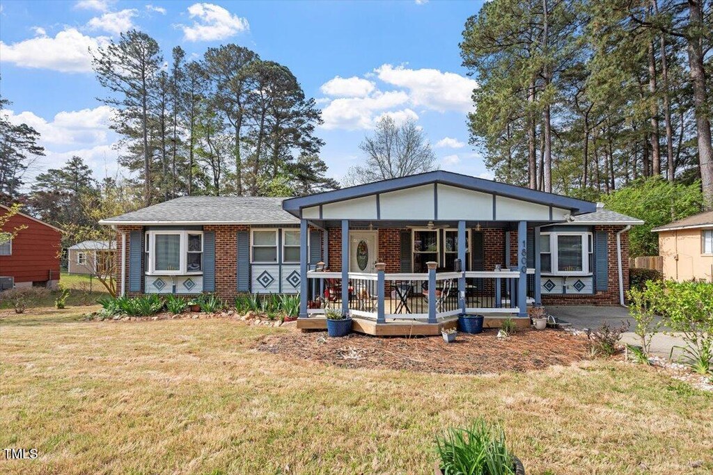 1800 Tee Dee St, Raleigh, NC 27610 - view of front of home with brick siding, a front lawn, and a porch
