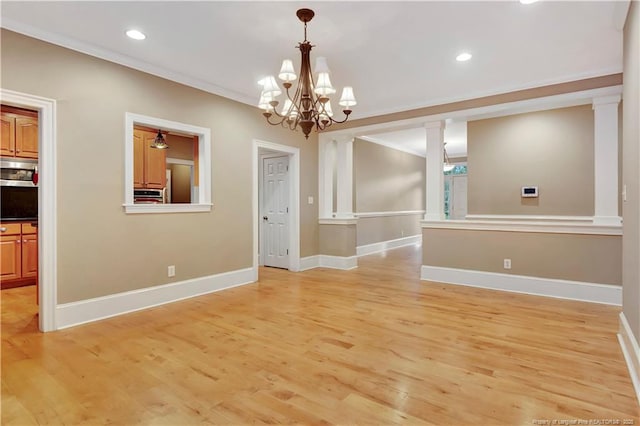 unfurnished dining area with baseboards, crown molding, and light wood-style floors