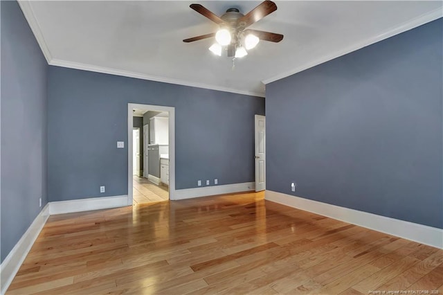 empty room with wood finished floors, ornamental molding, and a ceiling fan