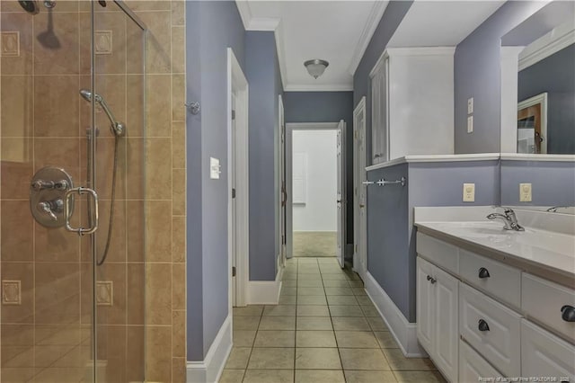 full bathroom featuring a stall shower, crown molding, vanity, tile patterned flooring, and baseboards
