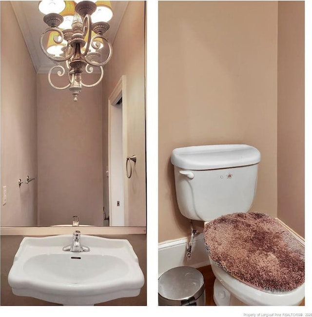 half bathroom featuring an inviting chandelier, toilet, and a sink