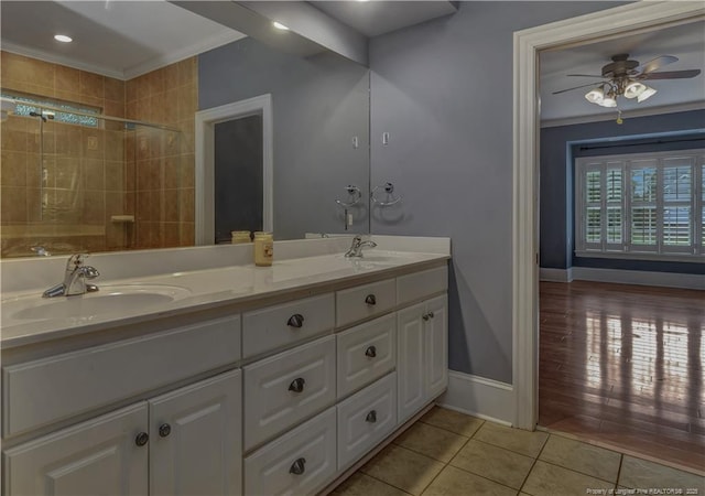 full bath featuring tile patterned flooring, a sink, and ornamental molding