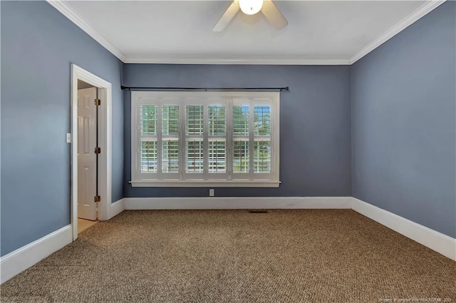 carpeted empty room featuring baseboards, a ceiling fan, and crown molding
