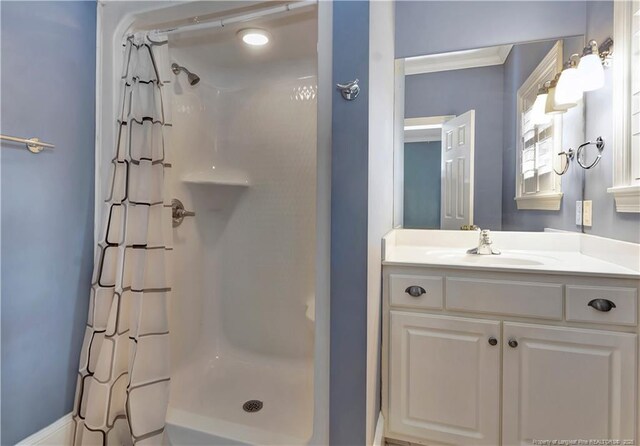 bathroom featuring a stall shower and vanity