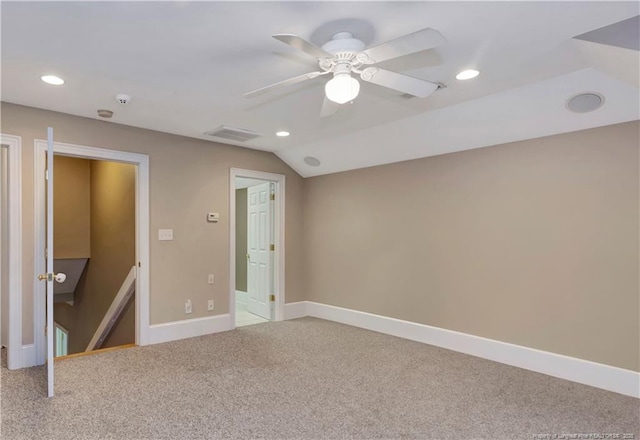 unfurnished bedroom featuring lofted ceiling, recessed lighting, carpet, baseboards, and visible vents