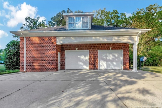 exterior space featuring brick siding and concrete driveway