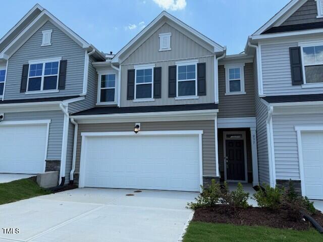 237 Shingle Oak Rd, Wake Forest, NC 27587 - view of property featuring a garage, driveway, and board and batten siding