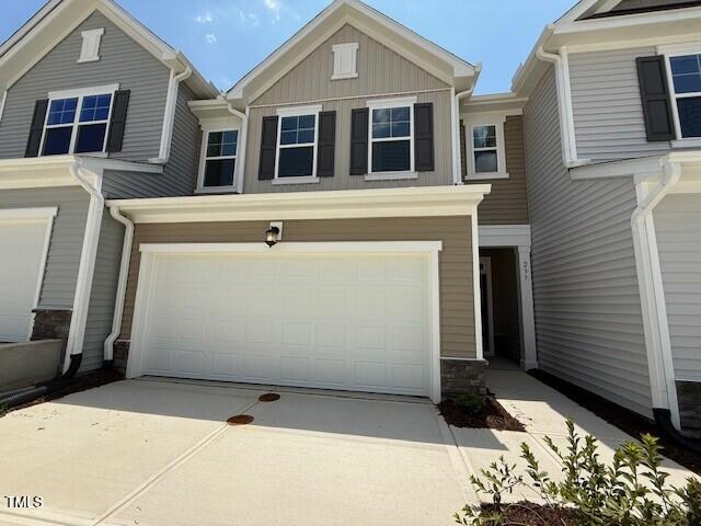 237 Shingle Oak Rd, Wake Forest, NC 27587 - view of property featuring a garage, board and batten siding, driveway, and stone siding