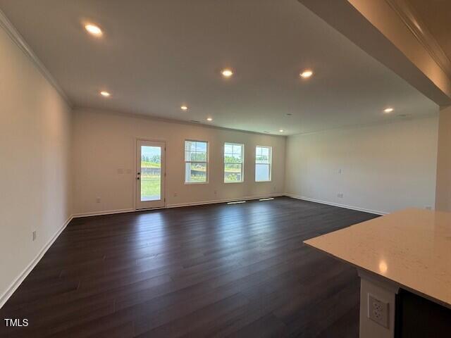 237 Shingle Oak Rd, Wake Forest, NC 27587 - unfurnished living room with dark wood finished floors, recessed lighting, and crown molding