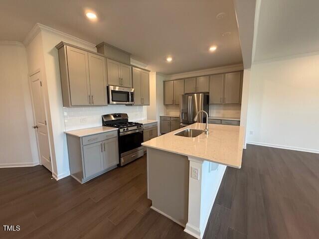 237 Shingle Oak Rd, Wake Forest, NC 27587 - kitchen with stainless steel appliances, gray cabinets, light countertops, dark wood finished floors, and crown molding