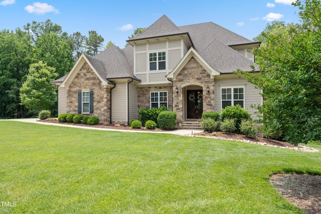 325 Forest Bridge Rd, Youngsville, NC 27596 - view of front of home featuring stone siding, roof with shingles, and a front yard