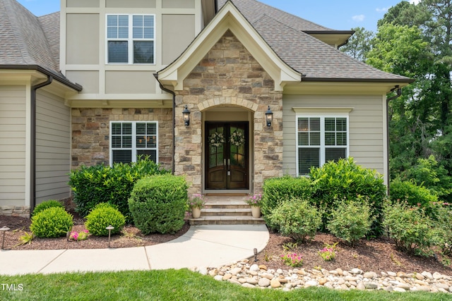 325 Forest Bridge Rd, Youngsville, NC 27596 - doorway to property featuring stone siding and a shingled roof