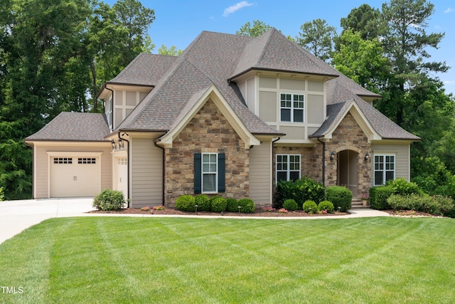 325 Forest Bridge Rd, Youngsville, NC 27596 - view of front of home with stone siding, a shingled roof, a garage, concrete driveway, and a front lawn