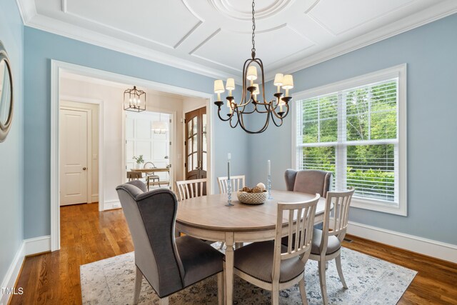 325 Forest Bridge Rd, Youngsville, NC 27596 - dining room with a chandelier, ornamental molding, wood finished floors, and baseboards