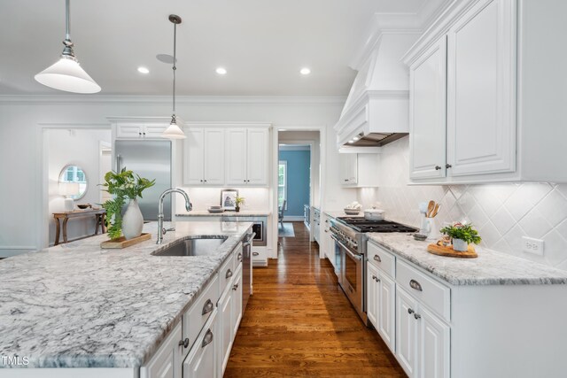 325 Forest Bridge Rd, Youngsville, NC 27596 - kitchen featuring high end stove, a sink, white cabinets, a kitchen island with sink, and crown molding
