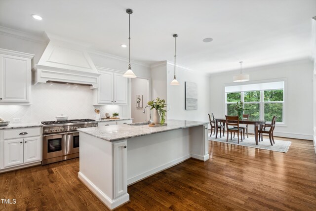 325 Forest Bridge Rd, Youngsville, NC 27596 - kitchen featuring range with two ovens, a sink, dark wood-type flooring, white cabinets, and crown molding