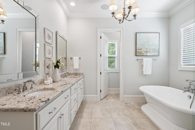 325 Forest Bridge Rd, Youngsville, NC 27596 - bathroom featuring a soaking tub, crown molding, double vanity, a chandelier, and baseboards