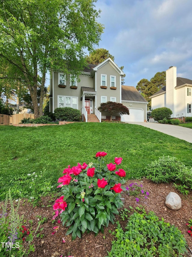 traditional-style home featuring concrete driveway and an attached garage