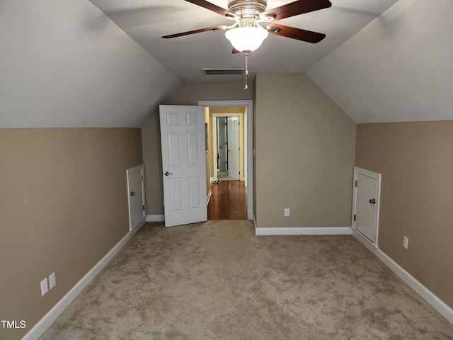 additional living space with a ceiling fan, lofted ceiling, carpet flooring, and baseboards