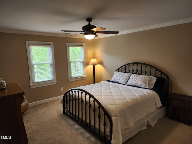 bedroom featuring ornamental molding, carpet floors, baseboards, and a ceiling fan
